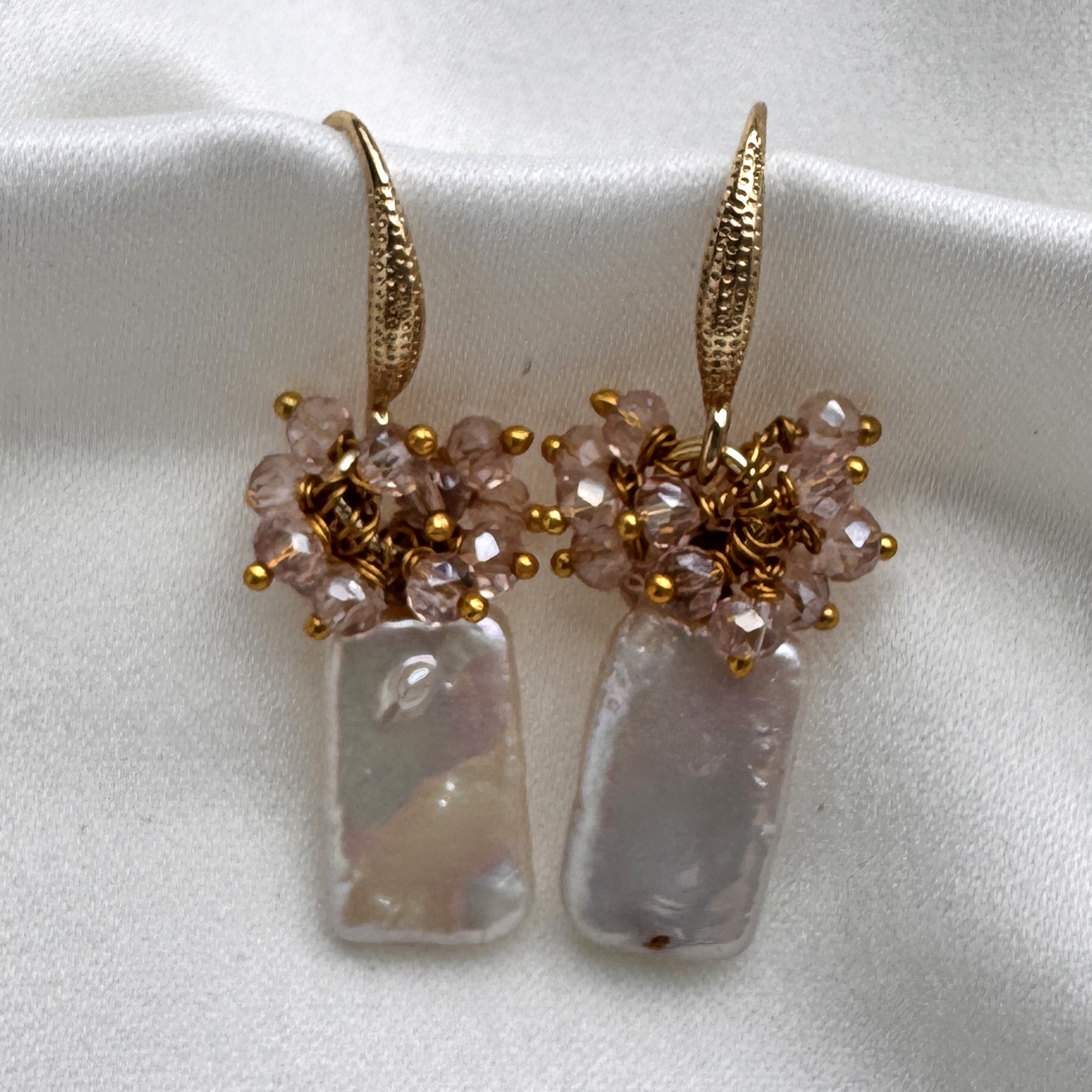 A pair of Keshi Pearl earrings with a luminous baroque pearl and a pink crystal cluster.