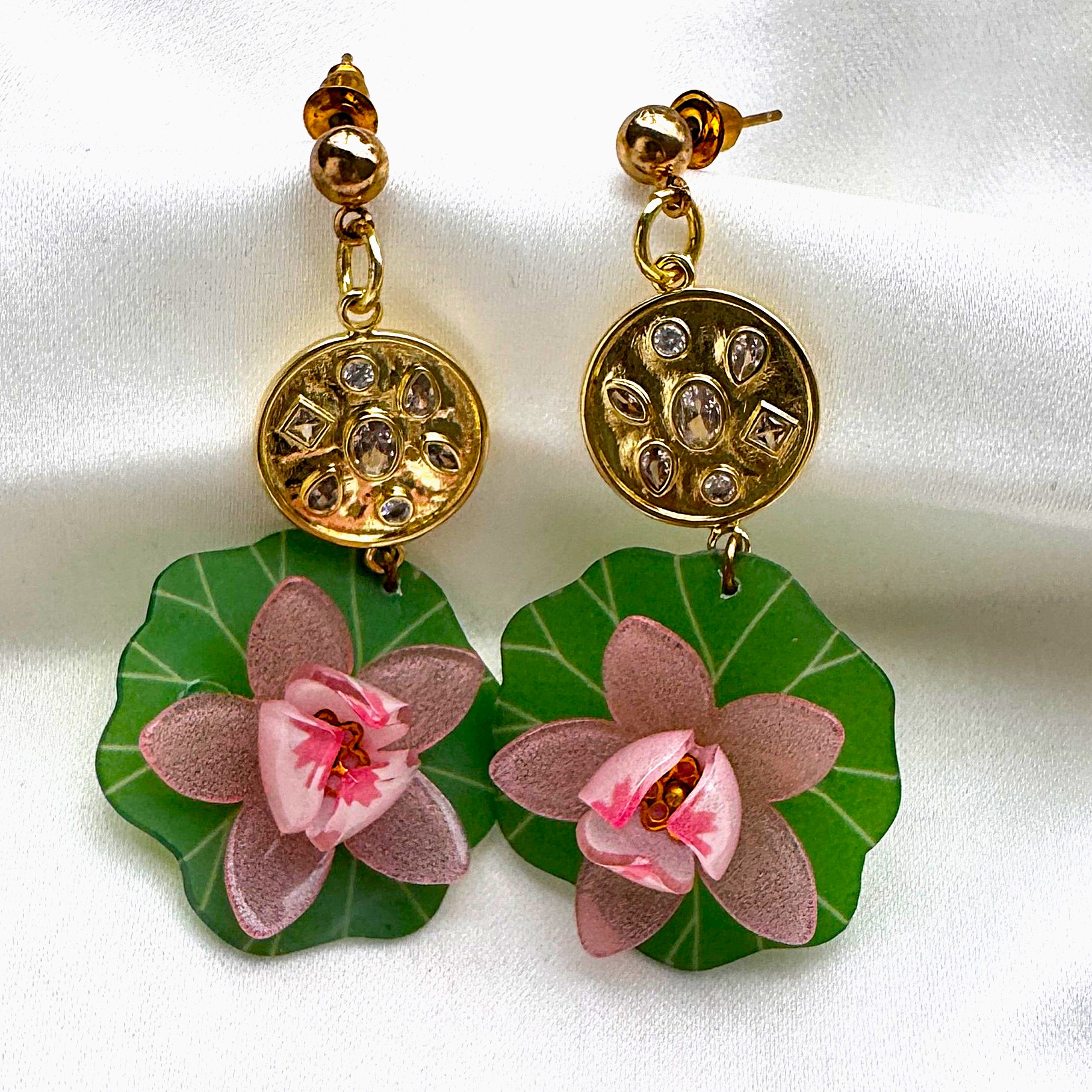 A pair of Lotus Danglers with painted lotus petals and a studded gold top.