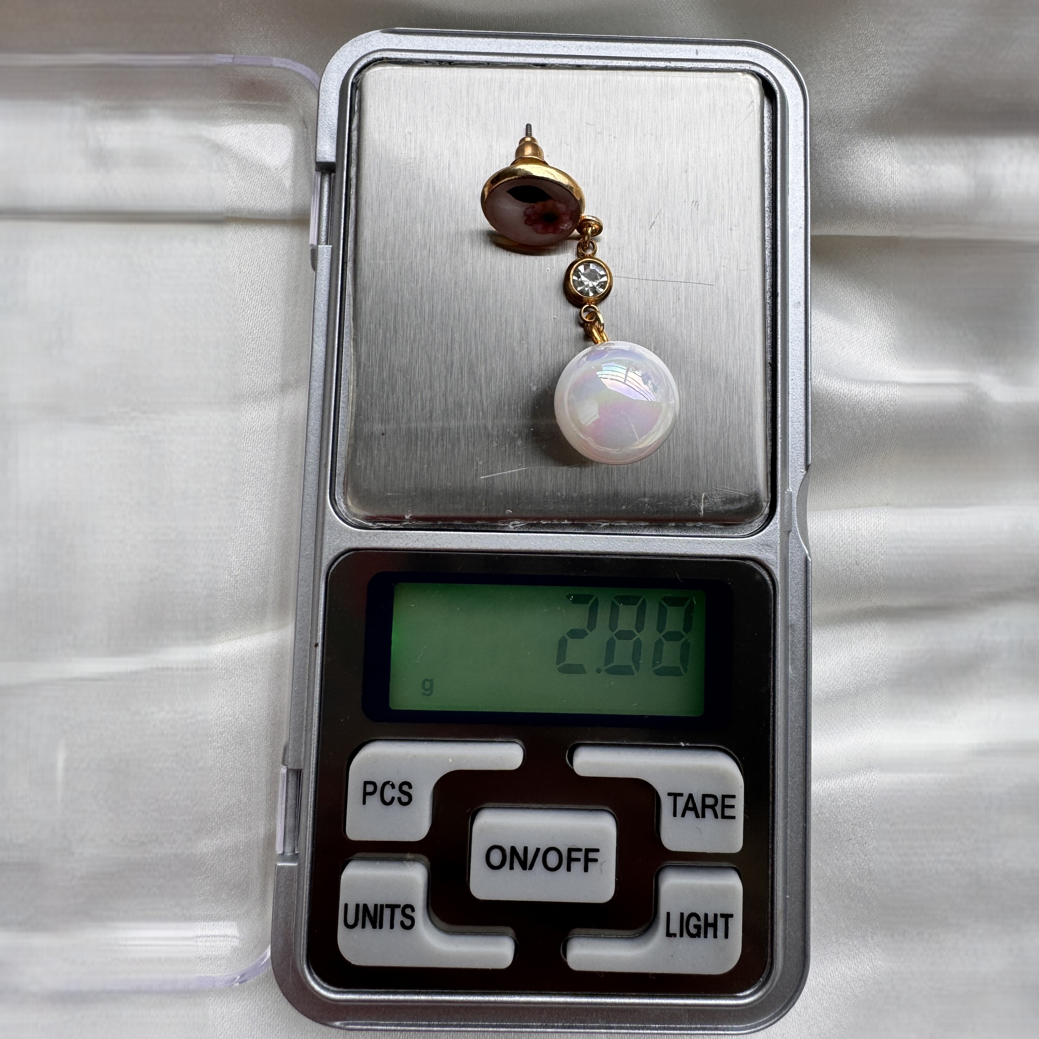Elegant Flicker of Flora earrings with miniature preserved flowers, pearls, and crystal details.