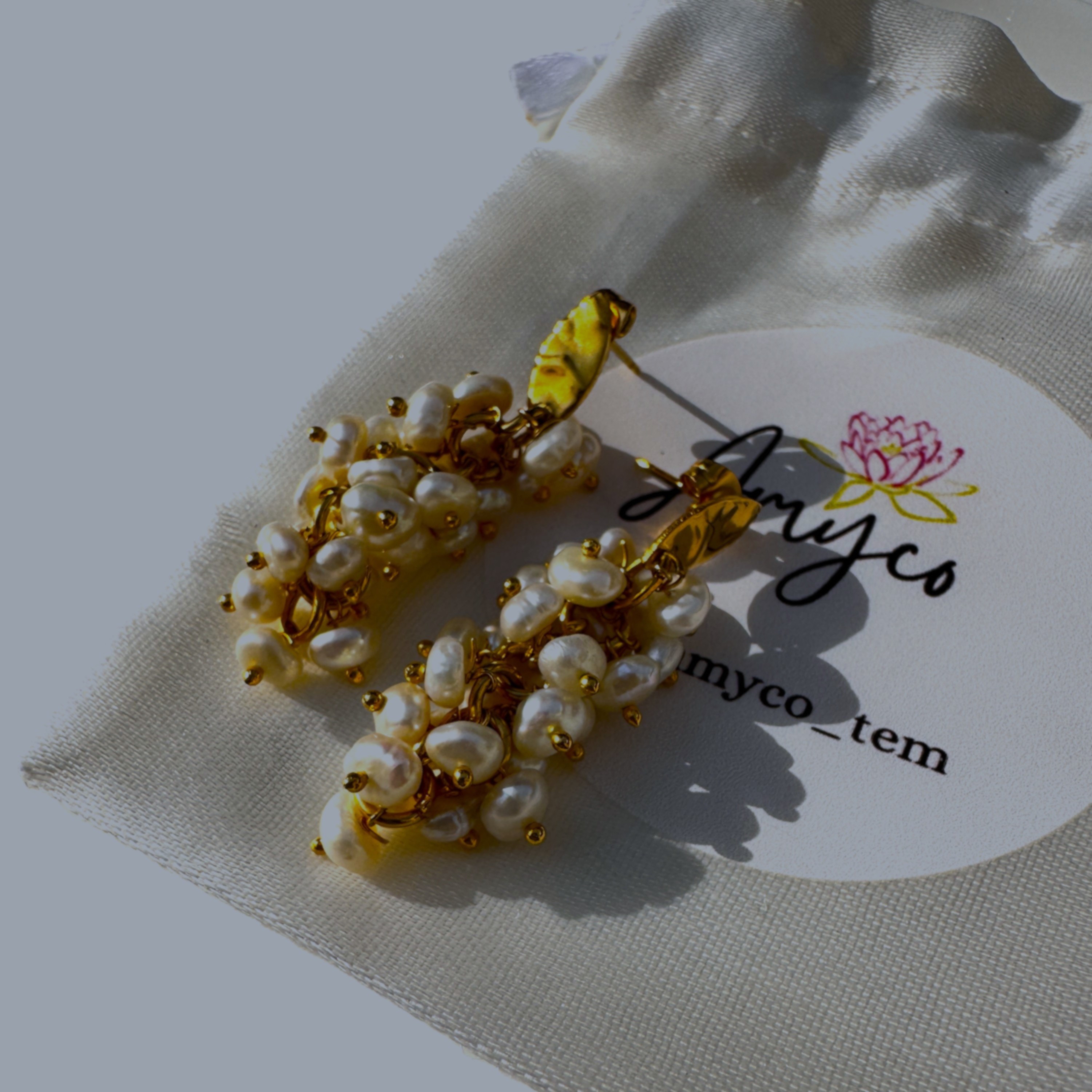 A pair of Pearl Bouquet earrings with a lush cluster of freshwater pearls on a gold setting.