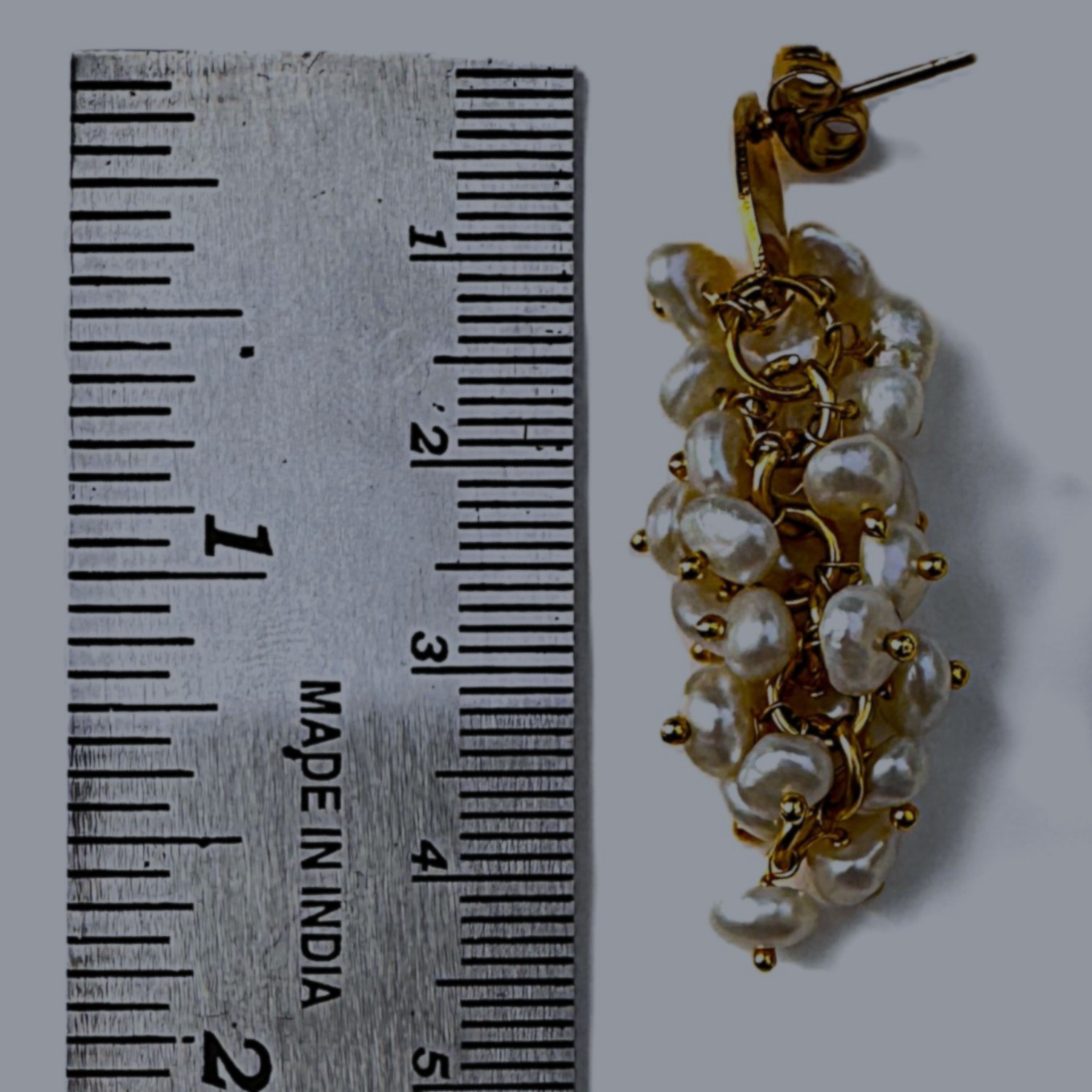 A pair of Pearl Bouquet earrings with a lush cluster of freshwater pearls on a gold setting.